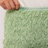 Close-up van de tailleband van de Arianne Skirt van Fluresk, met pluizige groene stof en elastische band.